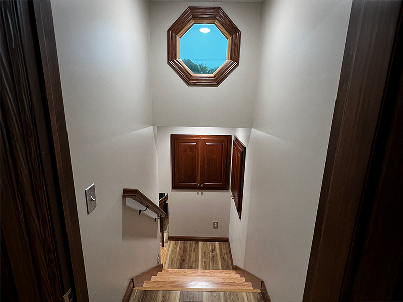 stairway Descending stairway with wooden floors with a porthole window atop the stairway hall.